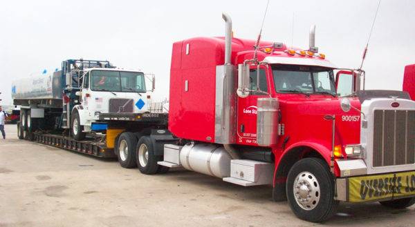Lone Star truck transporting airport vehicle