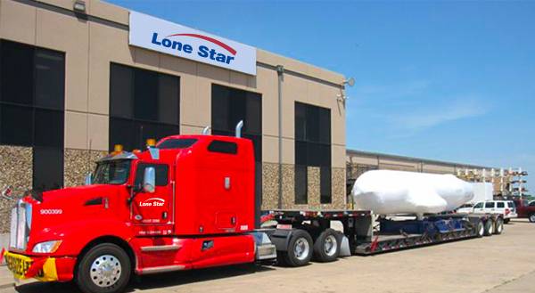 Lone Star truck with wrapped airplane piece on flatbed