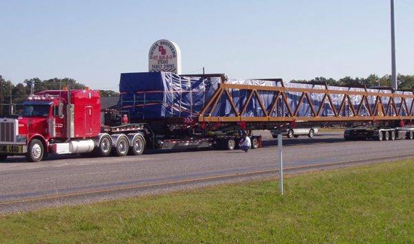 Lone Star Transportation truck hauling bridge materials on highway