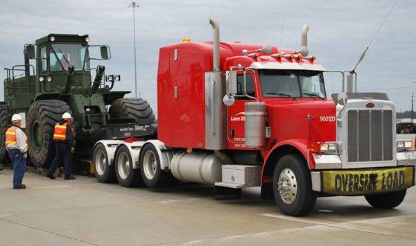 Lone Star truck with construction tractor on trailer