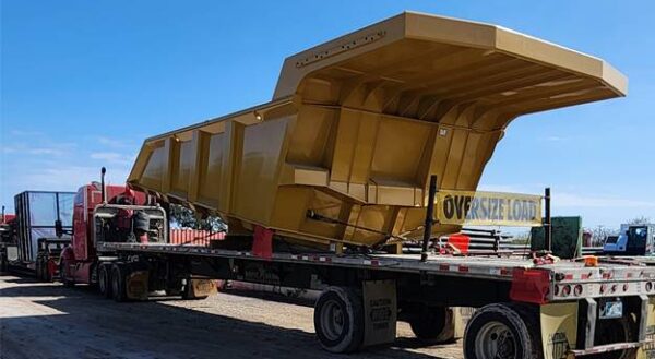 Lone Star flatbed hauling oversized construction equipment