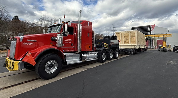 Lone Star truck hauling oversized industry show materials